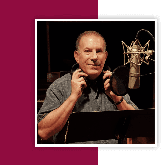 A man holding onto the ear of an old microphone